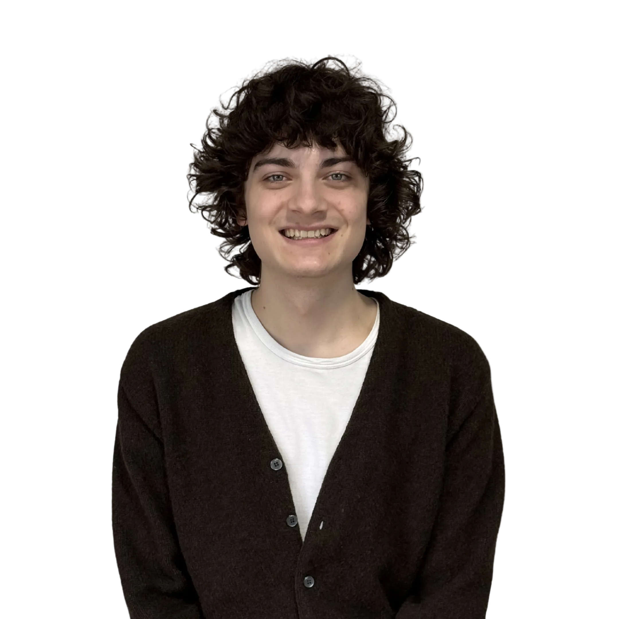 Person with curly hair wearing a dark cardigan over a white shirt on a white background